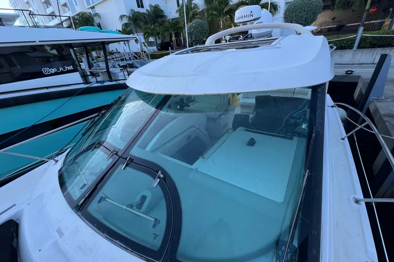  Yacht Photos Pics 2010 Sea Ray 450 Sundancer yacht docked, featuring sleek design and modern navigation equipment.