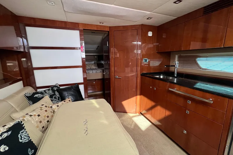  Yacht Photos Pics Luxurious interior of 2010 Sea Ray 450 Sundancer yacht with modern kitchen and cozy seating.