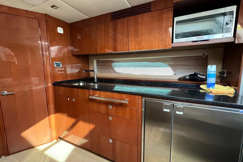  Yacht Photos Pics Luxurious 2010 Sea Ray 450 Sundancer yacht kitchen with wood cabinetry and modern appliances.