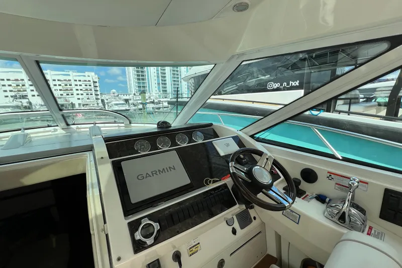  Yacht Photos Pics 2010 Sea Ray 450 Sundancer helm with Garmin navigation, docked in a marina.