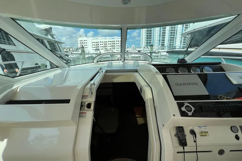  Yacht Photos Pics 2010 Sea Ray 450 Sundancer yacht cockpit with Garmin navigation, docked in a marina.