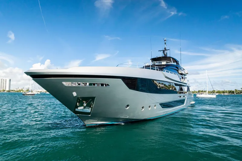 Tenacious Yacht Photos Pics Luxurious 2025 Riva 130' Bellissima yacht on clear blue water under a sunny sky.