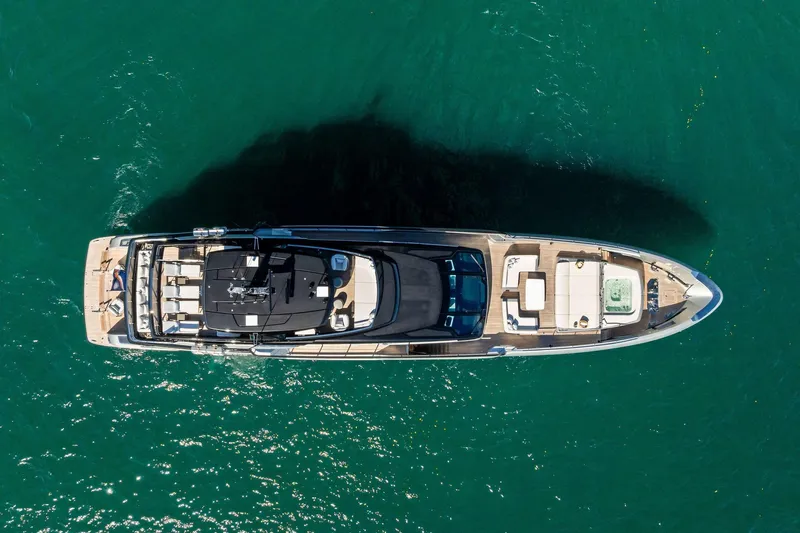 Tenacious Yacht Photos Pics Aerial view of 2025 Riva 130' Bellissima yacht on clear blue water.