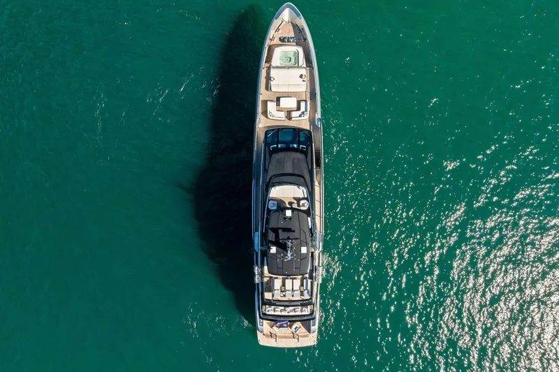 Tenacious Yacht Photos Pics Aerial view of 2025 Riva 130' Bellissima yacht on turquoise water.