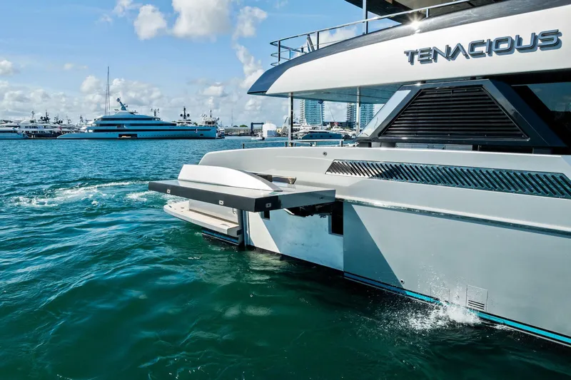 Tenacious Yacht Photos Pics Luxury yacht "Tenacious" on water, Riva 130' Bellissima, 2025 model, with scenic marina backdrop.