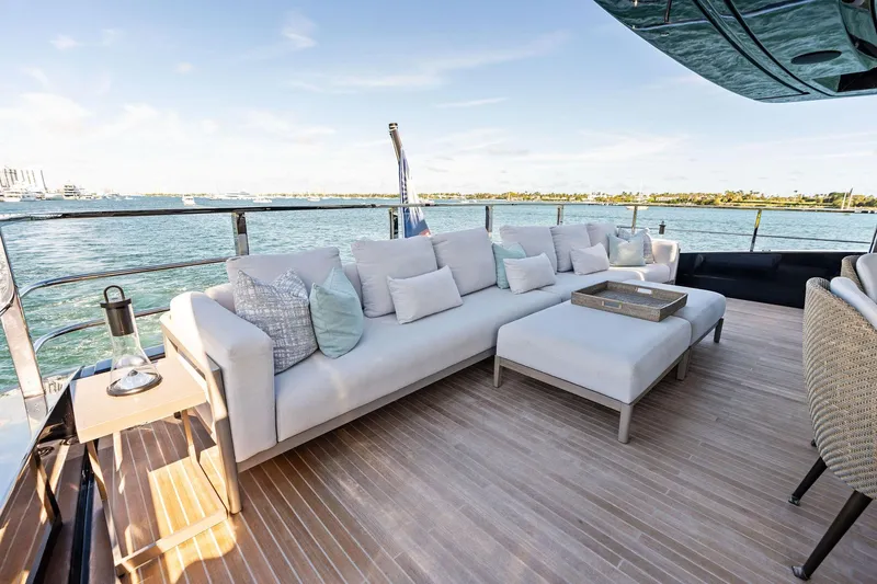 Tenacious Yacht Photos Pics Luxurious outdoor seating on 2025 Riva 130' Bellissima yacht, overlooking serene waters.