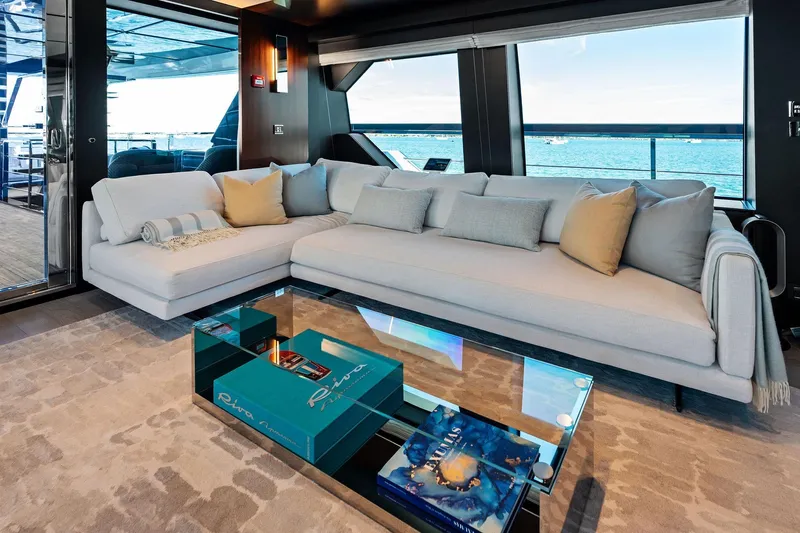 Tenacious Yacht Photos Pics Luxurious interior of 2025 Riva 130' Bellissima yacht with elegant seating and ocean view.