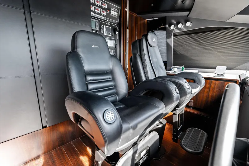 Tenacious Yacht Photos Pics Luxurious interior of 2025 Riva 130' Bellissima yacht with sleek black leather seating.