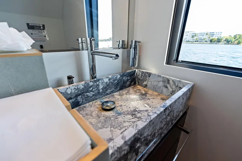Tenacious Yacht Photos Pics Luxurious marble sink in 2025 Riva 130' Bellissima yacht bathroom with ocean view.