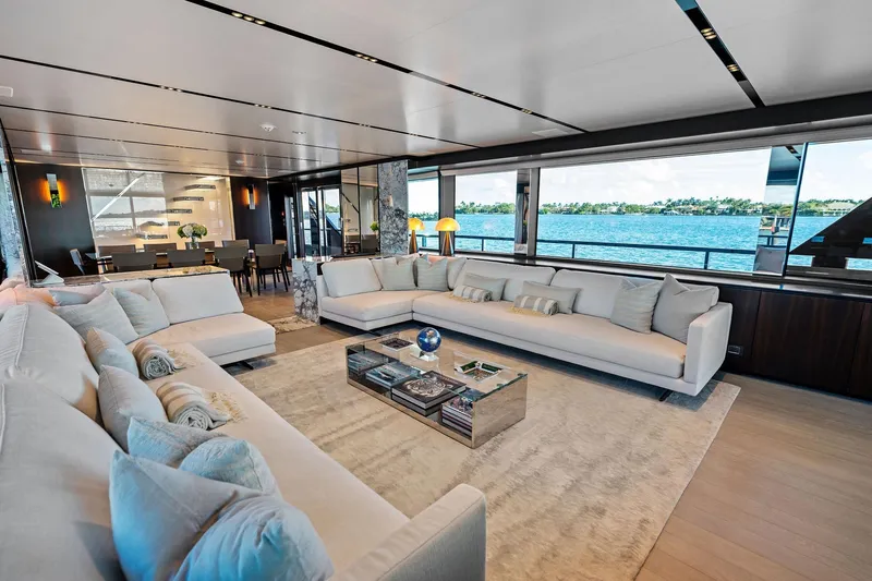 Tenacious Yacht Photos Pics Luxurious interior of 2025 Riva 130' Bellissima yacht with elegant seating and ocean view.