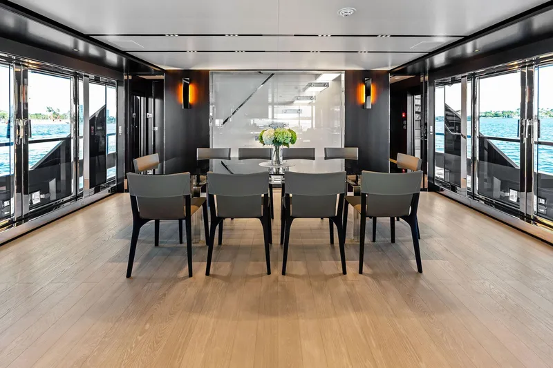 Tenacious Yacht Photos Pics Luxurious dining area on 2025 Riva 130' Bellissima yacht with elegant decor and ocean views.