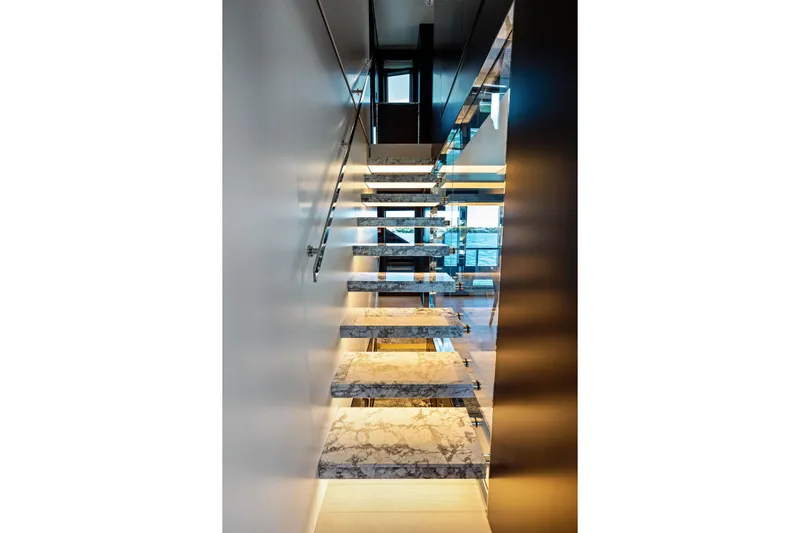 Tenacious Yacht Photos Pics Modern staircase with marble steps on the 2025 Riva 130' Bellissima yacht.