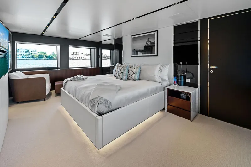 Tenacious Yacht Photos Pics Luxurious bedroom interior on 2025 Riva 130' Bellissima yacht, featuring modern design and waterfront views.