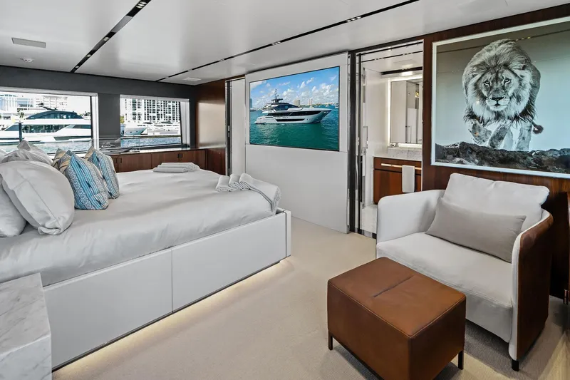 Tenacious Yacht Photos Pics Luxurious bedroom interior of 2025 Riva 130' Bellissima yacht with elegant decor and lion artwork.