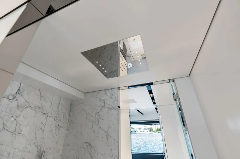 Tenacious Yacht Photos Pics Luxurious interior of 2025 Riva 130' Bellissima yacht with marble walls and modern design.