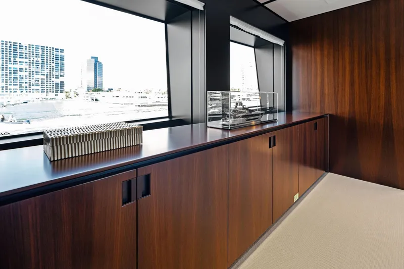 Tenacious Yacht Photos Pics Luxurious interior of 2025 Riva 130' Bellissima yacht with sleek wood paneling and large windows.