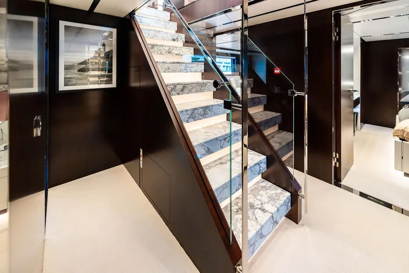 Tenacious Yacht Photos Pics Luxurious interior of 2025 Riva 130' Bellissima yacht with elegant marble staircase.