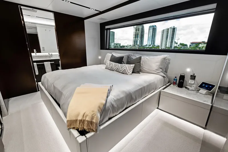 Tenacious Yacht Photos Pics Luxurious bedroom interior of 2025 Riva 130' Bellissima yacht with modern design and city view.