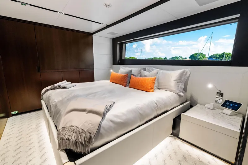 Tenacious Yacht Photos Pics Luxurious bedroom interior of 2025 Riva 130' Bellissima yacht with large window view.