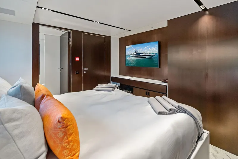 Tenacious Yacht Photos Pics Luxurious bedroom interior on 2025 Riva 130' Bellissima yacht with modern decor and TV.