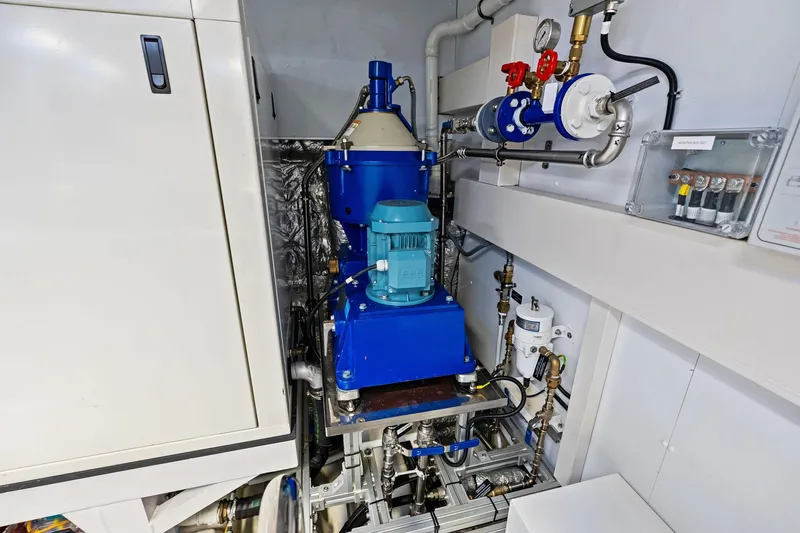 Tenacious Yacht Photos Pics Engine room machinery of 2025 Riva 130' Bellissima yacht, featuring blue mechanical components.