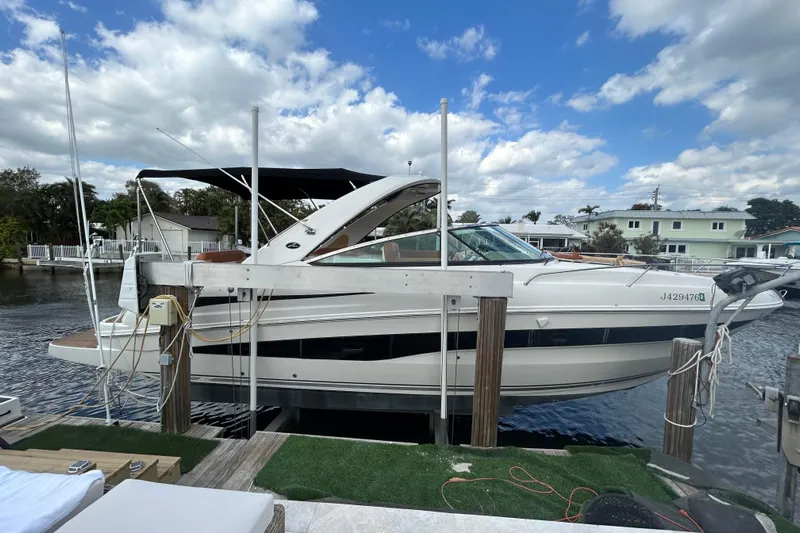 Mr Bojangles Yacht Photos Pics 2014 Sea Ray 370 Venture boat docked under a partly cloudy sky.