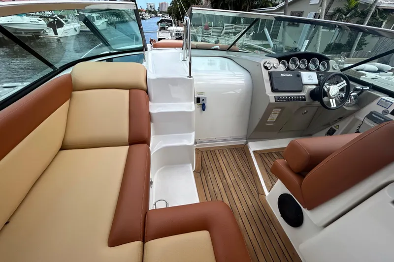 Mr Bojangles Yacht Photos Pics 2014 Sea Ray 370 Venture boat interior with tan and brown seating, wooden flooring, and control panel.