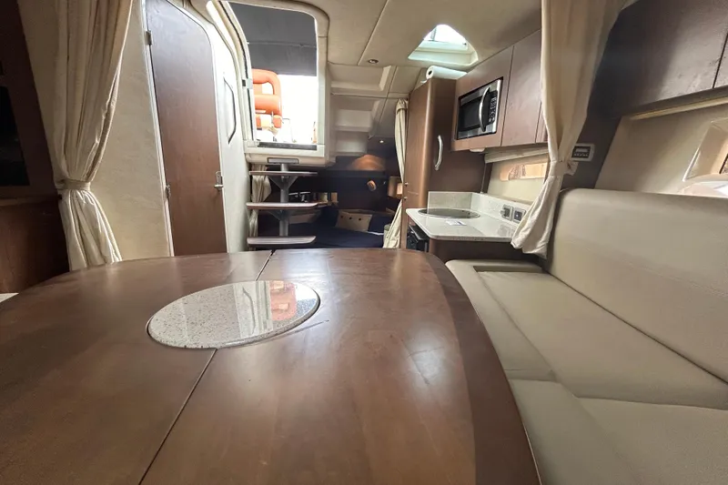 Mr Bojangles Yacht Photos Pics Interior of a 2014 Sea Ray 370 Venture yacht with dining area and kitchenette.