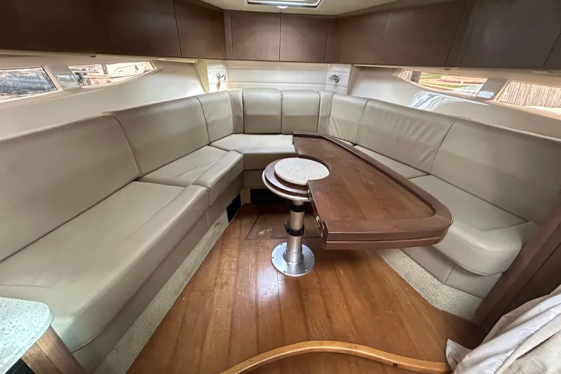 Mr Bojangles Yacht Photos Pics Luxurious interior of 2014 Sea Ray 370 Venture yacht with elegant seating and wooden table.