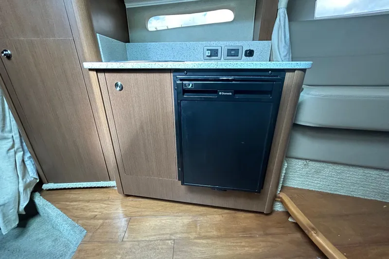 Mr Bojangles Yacht Photos Pics 2014 Sea Ray 370 Venture interior with compact kitchenette and Dometic fridge.