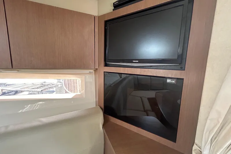 Mr Bojangles Yacht Photos Pics Interior of 2014 Sea Ray 370 Venture with TV and wooden cabinetry.