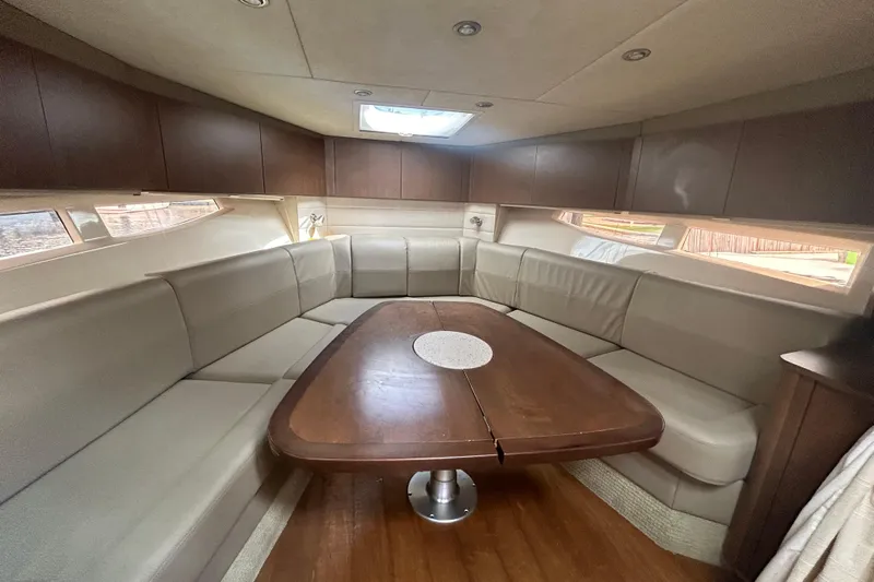 Mr Bojangles Yacht Photos Pics Luxurious interior of 2014 Sea Ray 370 Venture yacht with spacious seating and wooden table.