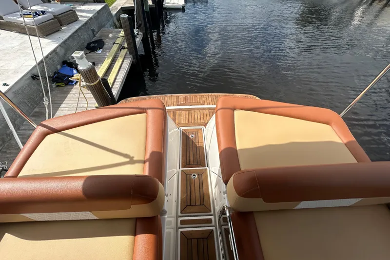 Mr Bojangles Yacht Photos Pics 2014 Sea Ray 370 Venture boat with cushioned seating and wooden deck by the water.