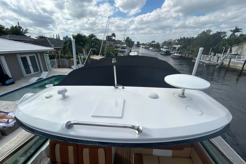 Mr Bojangles Yacht Photos Pics 2014 Sea Ray 370 Venture yacht docked by a canal under a cloudy sky.