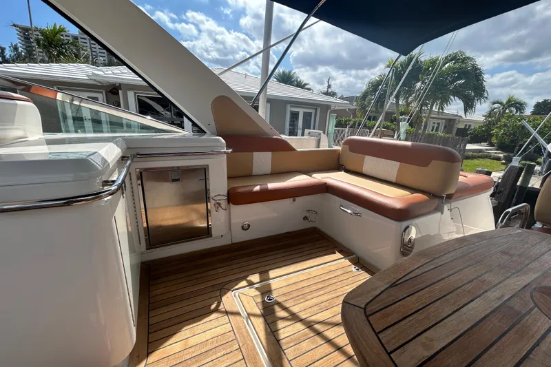 Mr Bojangles Yacht Photos Pics 2014 Sea Ray 370 Venture yacht interior with cushioned seating and wooden deck.