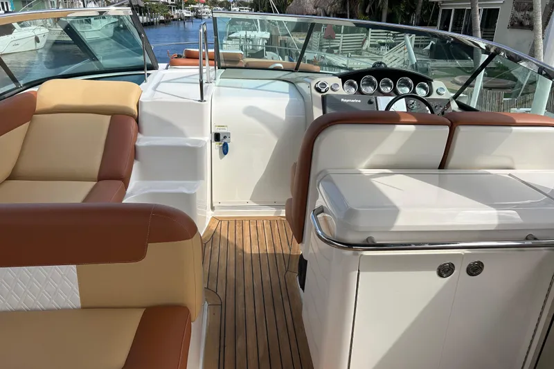 Mr Bojangles Yacht Photos Pics 2014 Sea Ray 370 Venture boat interior with tan and brown seating, wooden deck, and control panel.