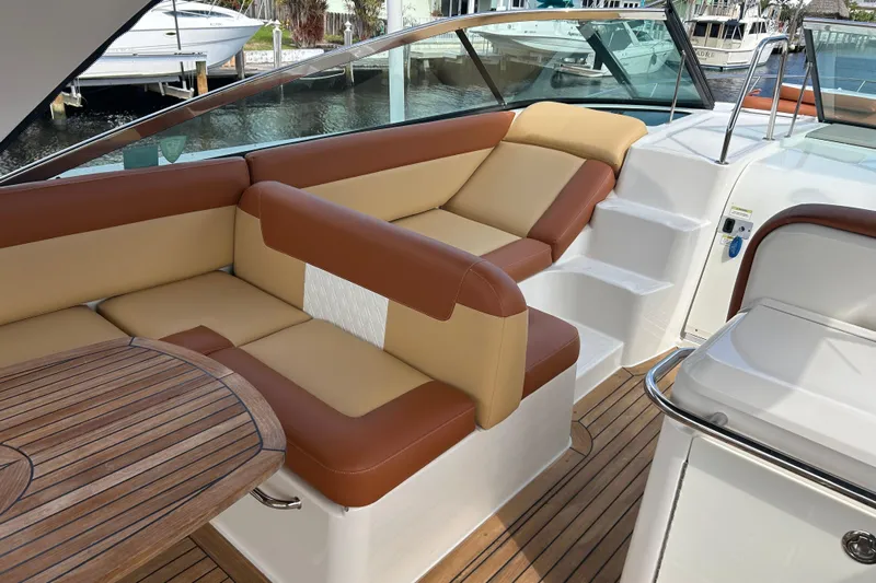 Mr Bojangles Yacht Photos Pics 2014 Sea Ray 370 Venture boat interior with tan and brown seating, wooden table, and steps.