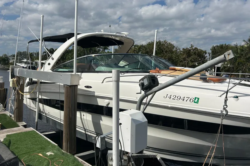 Mr Bojangles Yacht Photos Pics 2014 Sea Ray 370 Venture docked under a cloudy sky.