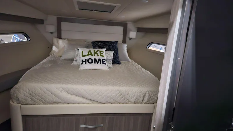  Yacht Photos Pics 2020 Regal 38 Grand Coupe cabin with cozy bed and decorative pillows.