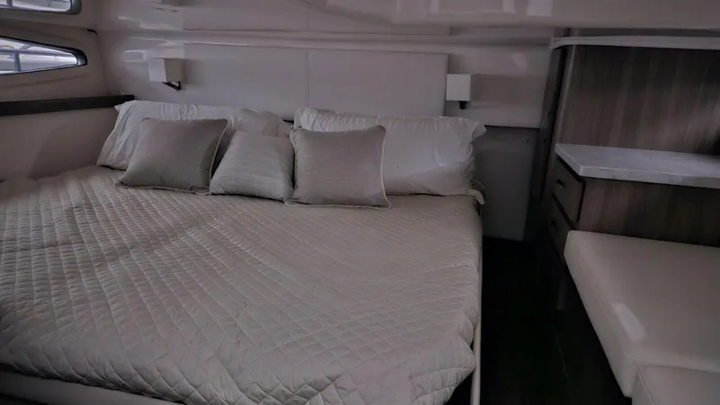  Yacht Photos Pics Luxurious bedroom interior of 2020 Regal 38 Grand Coupe yacht with cozy bedding.