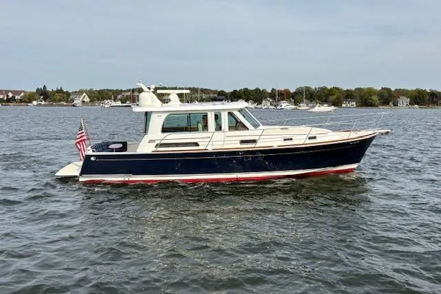  Yacht Photos Pics 2015 Sabre 42 Salon Express yacht cruising on calm waters with scenic shoreline backdrop.