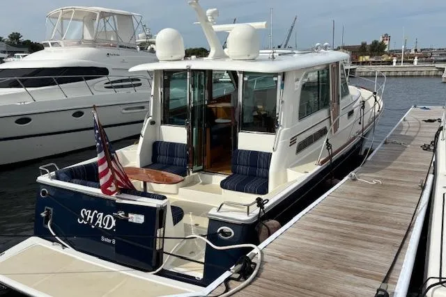  Yacht Photos Pics 2015 Sabre 42 Salon Express docked, featuring a spacious deck and American flag.