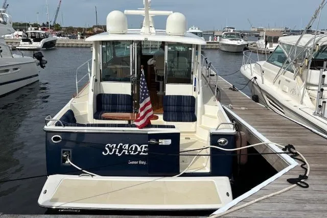  Yacht Photos Pics 2015 Sabre 42 Salon Express docked at marina, rear view with American flag.