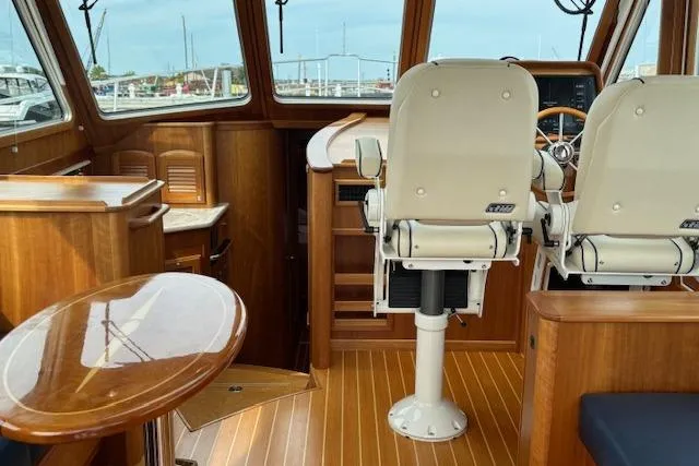  Yacht Photos Pics Interior of 2015 Sabre 42 Salon Express yacht with wooden flooring and helm chairs.