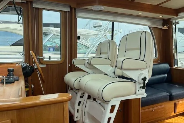 Yacht Photos Pics Interior of 2015 Sabre 42 Salon Express with plush seating and wooden accents.