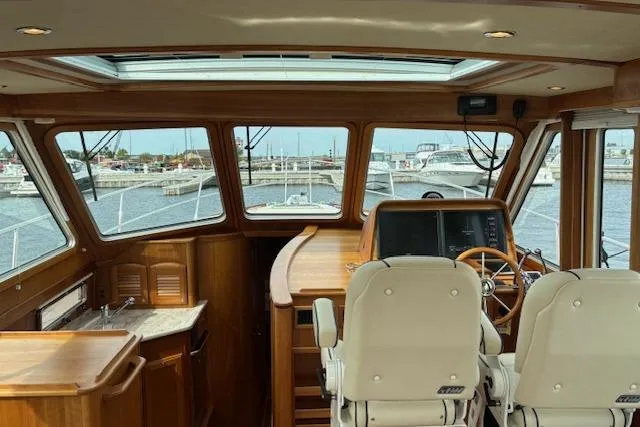  Yacht Photos Pics Interior view of 2015 Sabre 42 Salon Express yacht cockpit with helm and seating.