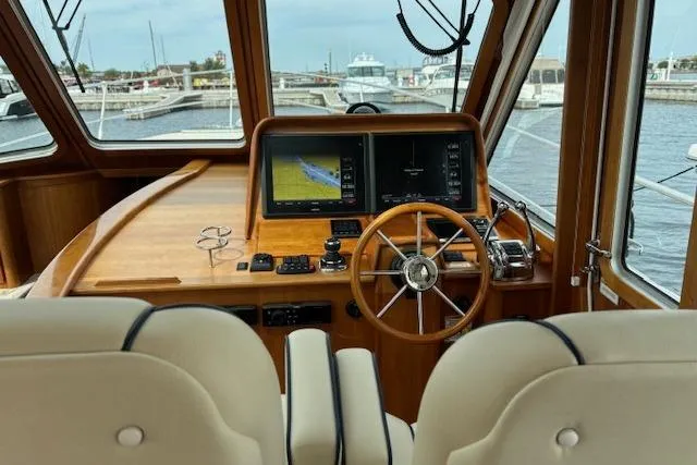  Yacht Photos Pics 2015 Sabre 42 Salon Express helm with wooden steering wheel and navigation screens.