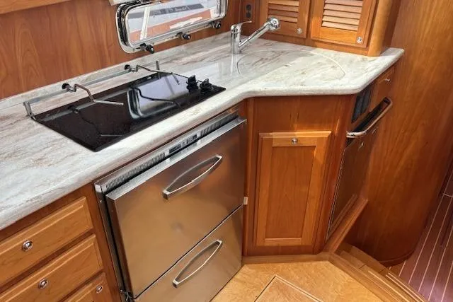  Yacht Photos Pics 2015 Sabre 42 Salon Express kitchen with stove, sink, and stainless steel appliances.