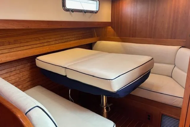  Yacht Photos Pics Interior of 2015 Sabre 42 Salon Express with cushioned seating and wooden paneling.