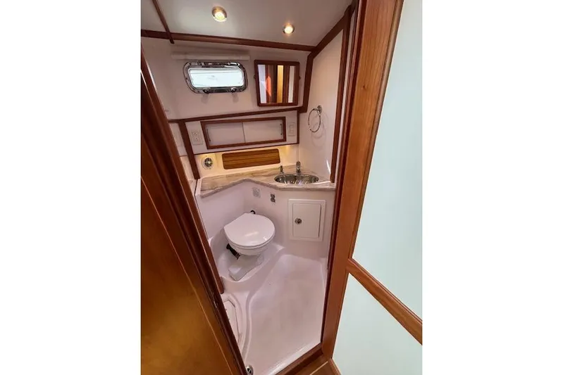  Yacht Photos Pics 2015 Sabre 42 Salon Express bathroom with sink, toilet, and wooden accents.